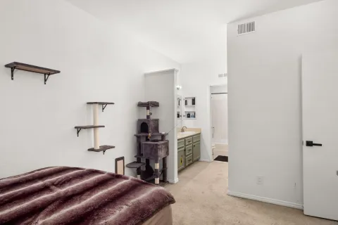 a bedroom with a bed and cabinets