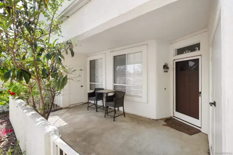 a balcony with furniture and potted plants