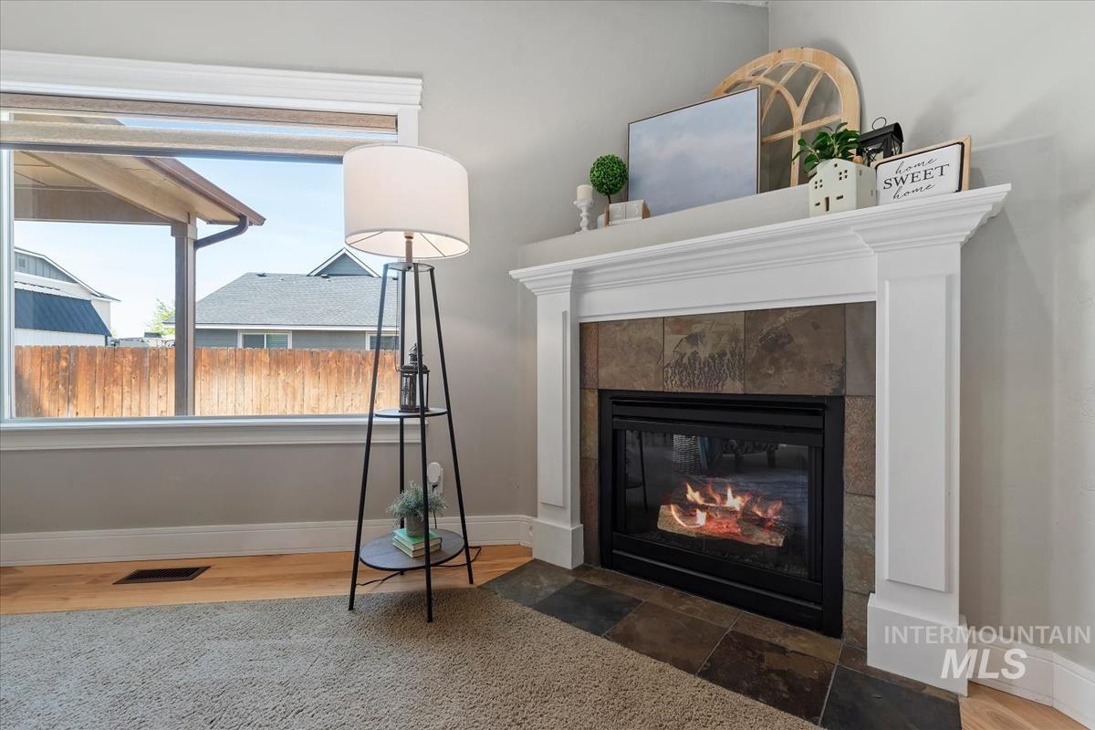 640 Southwest Miner Street Mountain Home, ID 83647 - Photo 28 of 35 Living area featuring a fireplace with a white mantle and slate tile surround