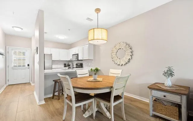 a view of a dining room with furniture wooden floor and a chandelier