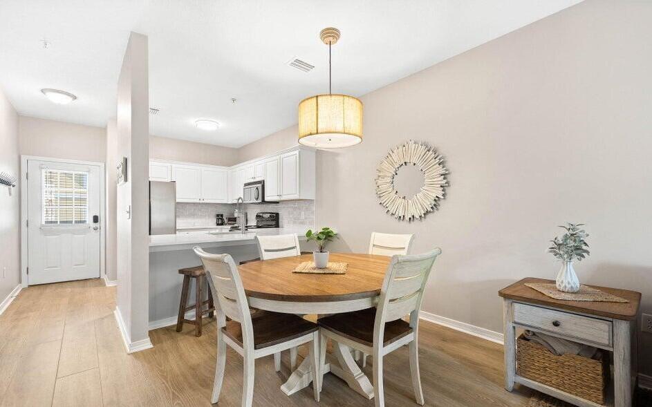 a view of a dining room with furniture wooden floor and a chandelier
