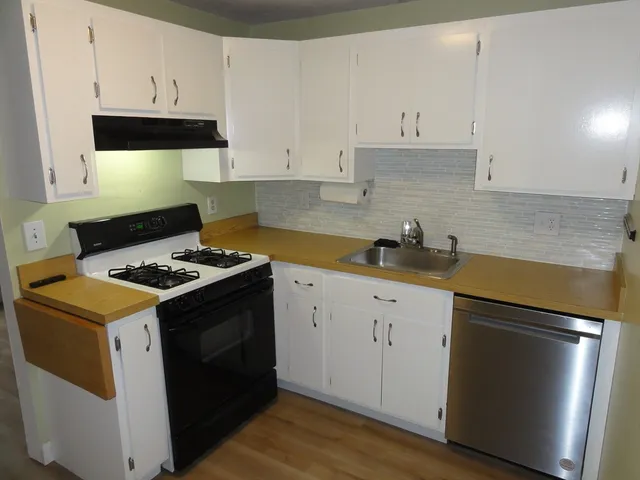 a kitchen with a stove and a refrigerator