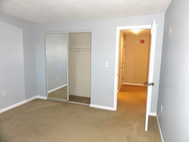 an empty room with closet area