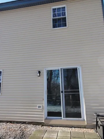 a view of a house with backyard and a tree
