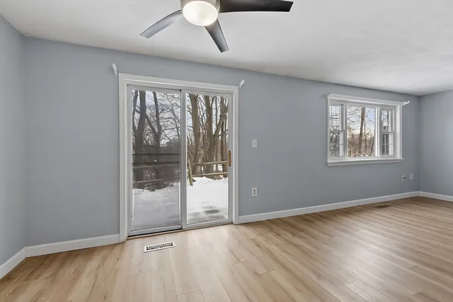 a view of an empty room with glass door