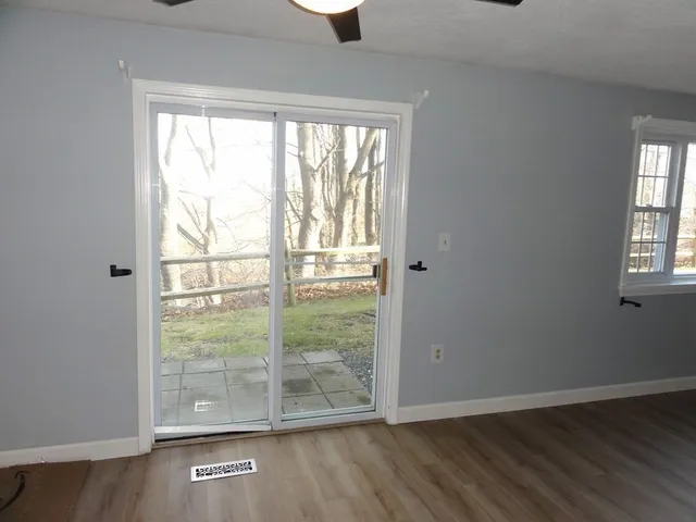 wooden floor in an empty room with a window