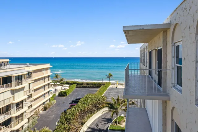 a view of a balcony with furniture and wooden floor