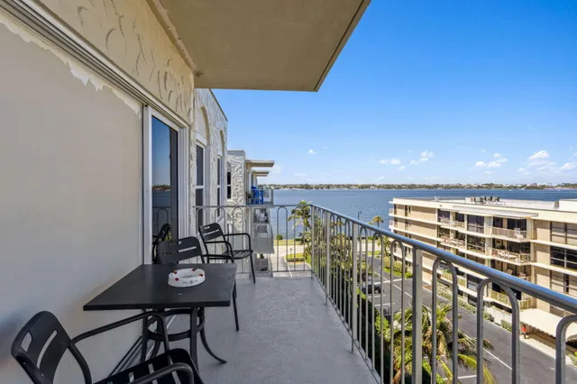a view of a balcony with chairs and table