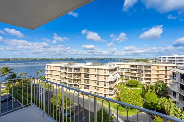 a view of a house with pool and chairs