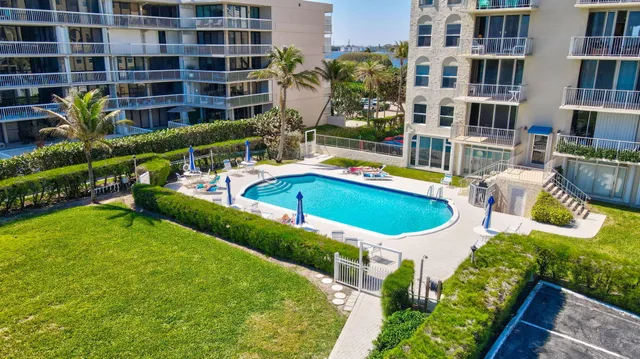 a view of a house with pool and chairs