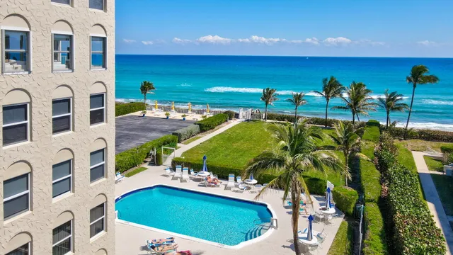 a view of swimming pool with an outdoor seating and a yard
