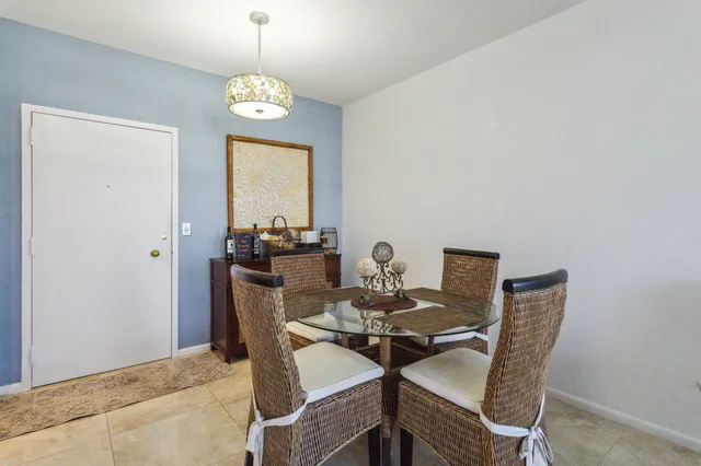 a dining room with furniture a rug and a mirror