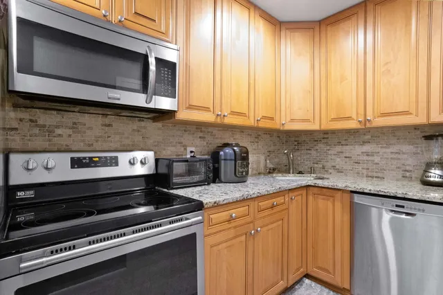 a kitchen with a stove microwave and sink