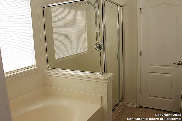 a bathroom with a bathtub and a shower