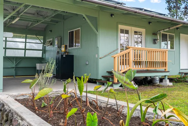a view of a house with backyard porch and furniture