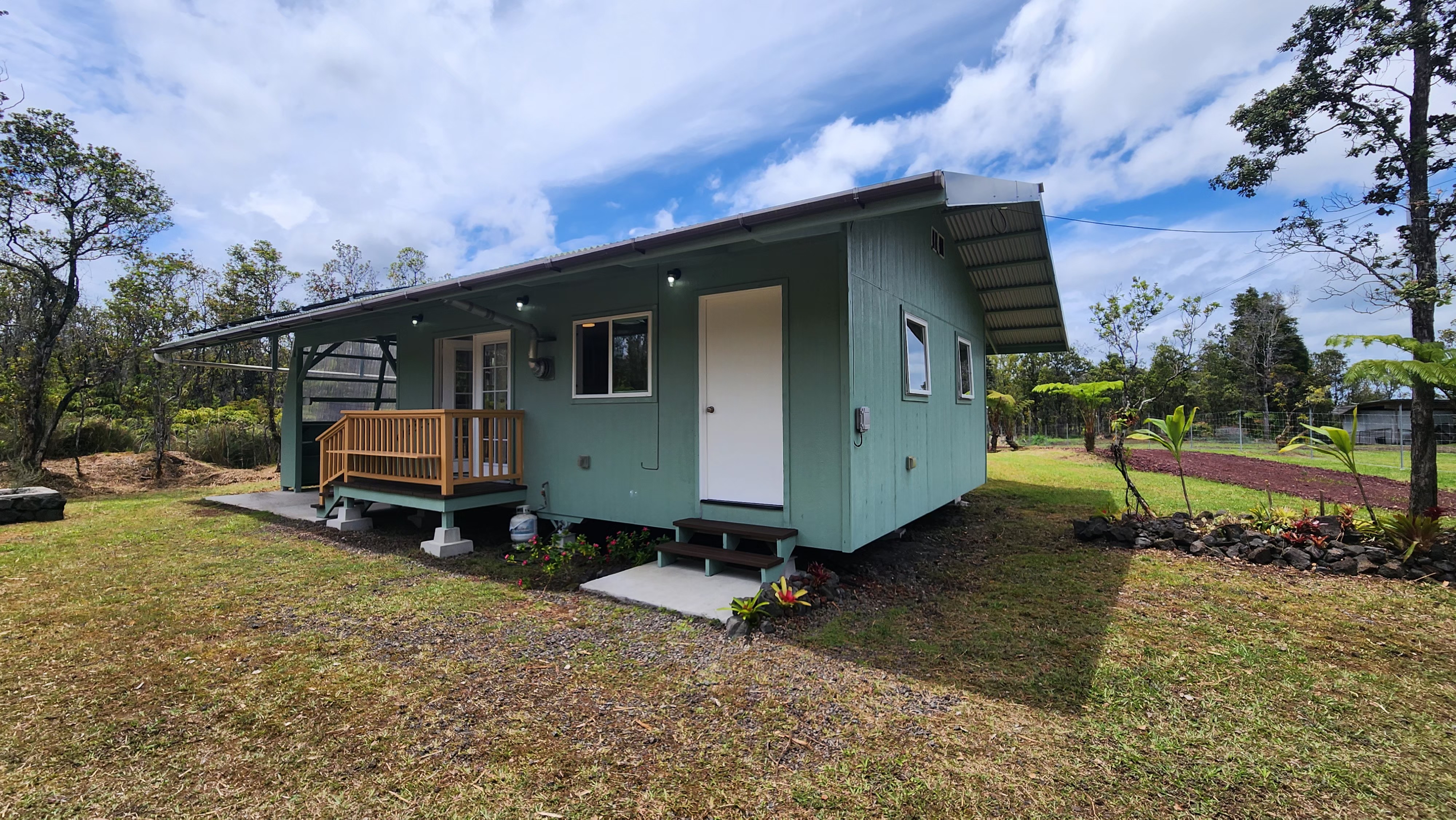 11-2449 Ohialani Road Mountain View, HI 96771 - Photo 3 of 10 a backyard of a house with barbeque oven table and chairs