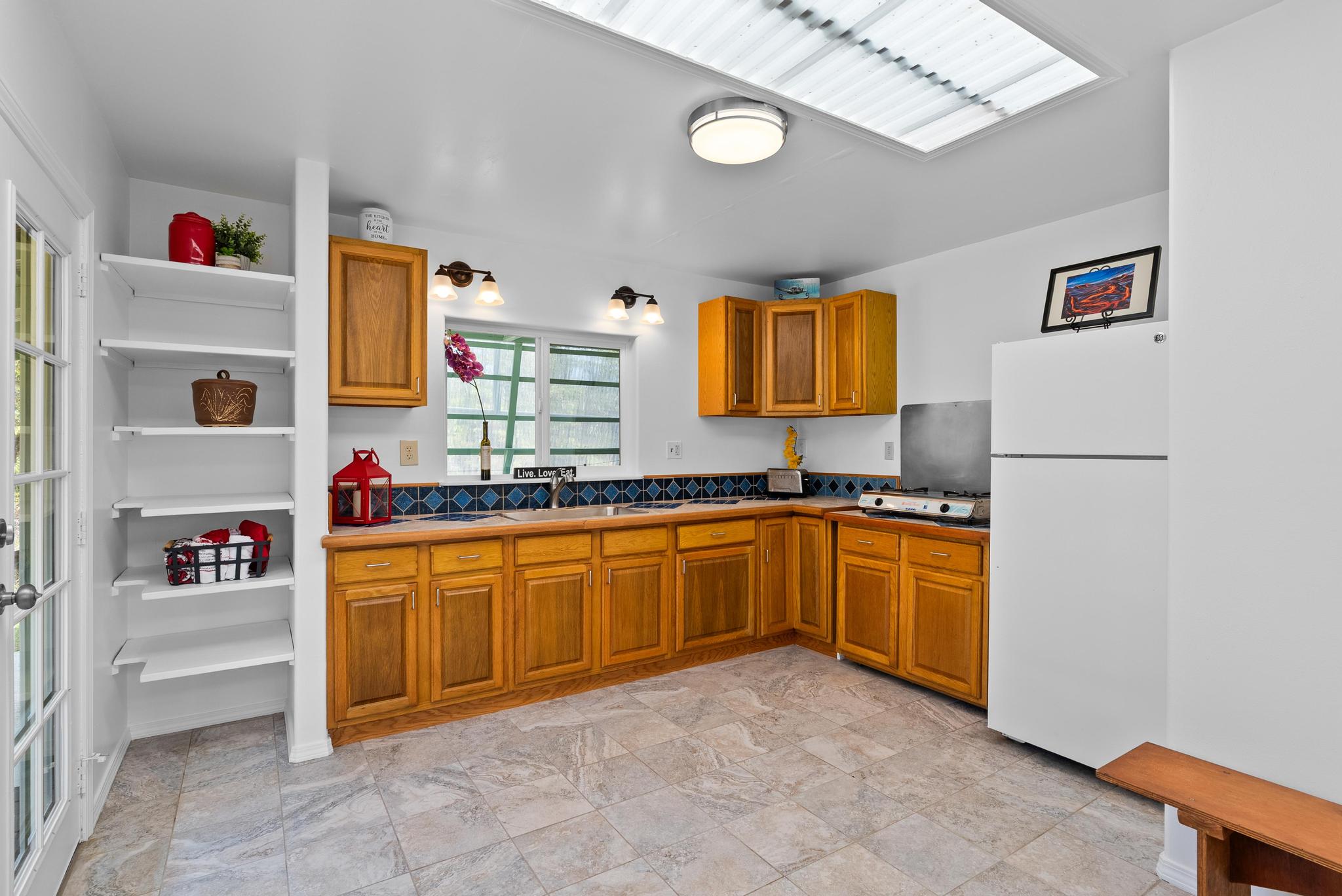 11-2449 Ohialani Road Mountain View, HI 96771 - Photo 5 of 10 a kitchen with stainless steel appliances granite countertop a refrigerator and a sink