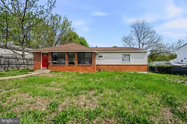 a view of a house with a backyard and a patio