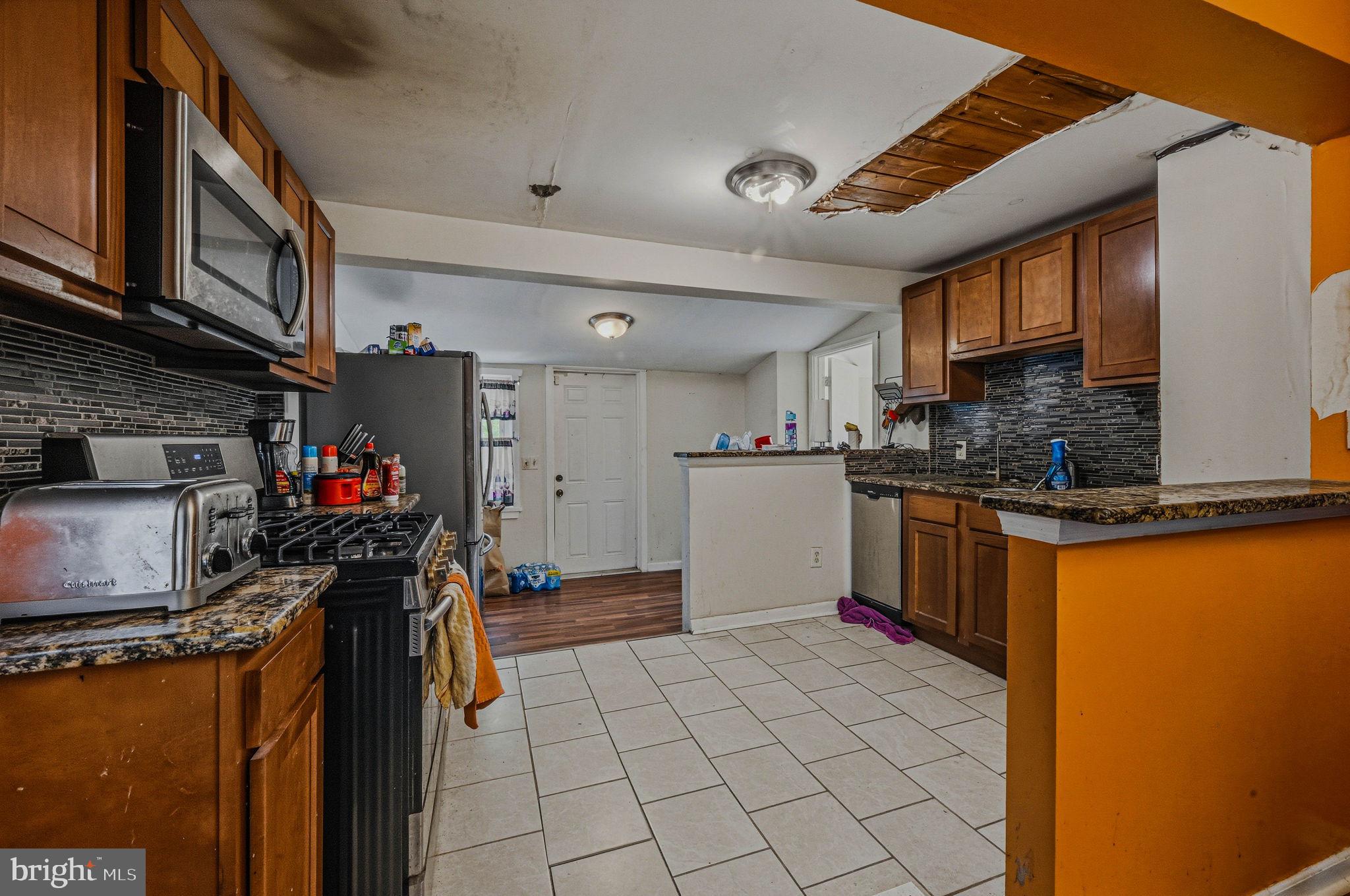 408 West 9th Street New Castle, DE 19720 - Photo 10 of 29 a kitchen with a refrigerator and a stove