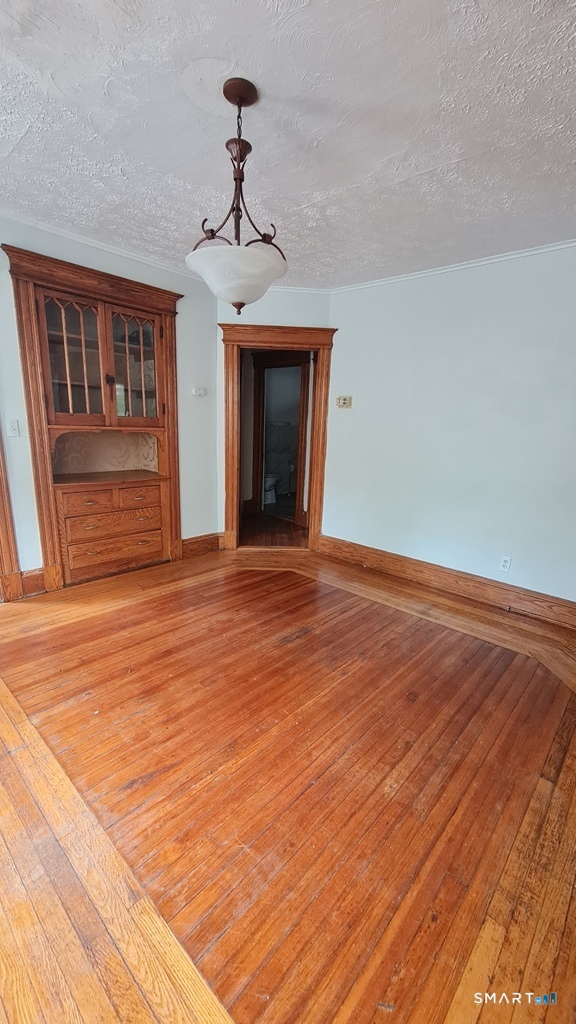 64-66 Ridge Street Manchester, CT 06040 - Photo 14 of 21 a view of an empty room with wooden floor and a window