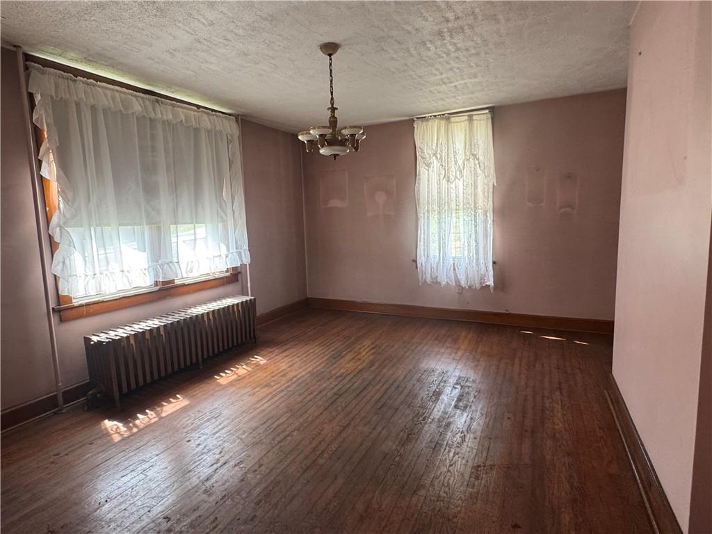 797 Walnut Hill Road Uniontown, PA 15401 - Photo 14 of 39 an empty room with wooden floor and windows
