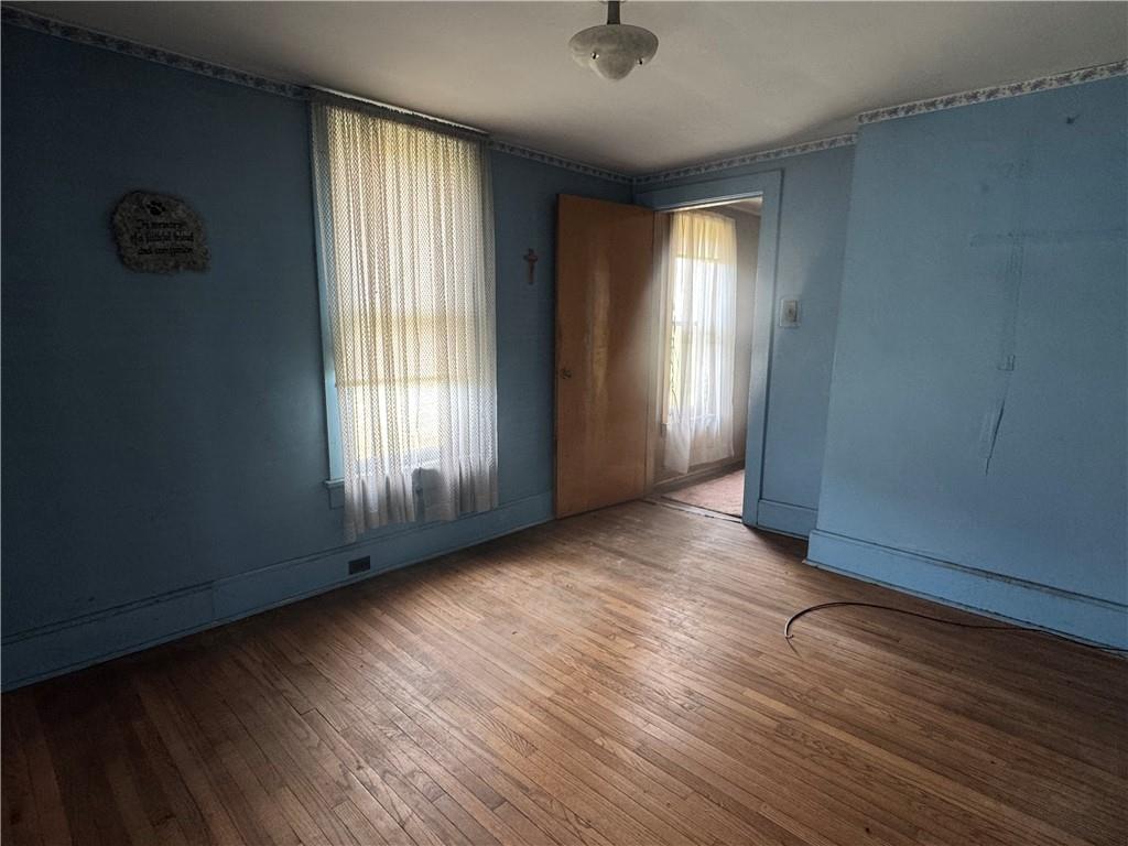 797 Walnut Hill Road Uniontown, PA 15401 - Photo 17 of 39 an empty room with wooden floor and windows