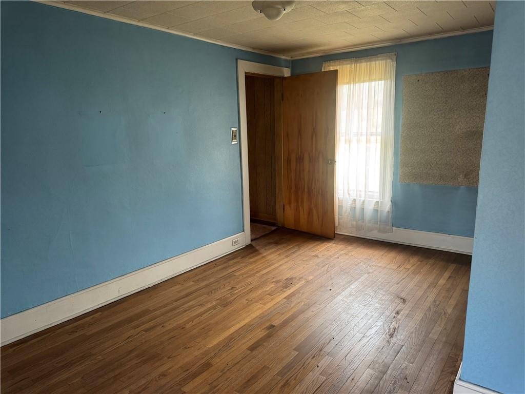 797 Walnut Hill Road Uniontown, PA 15401 - Photo 19 of 39 an empty room with wooden floor and windows
