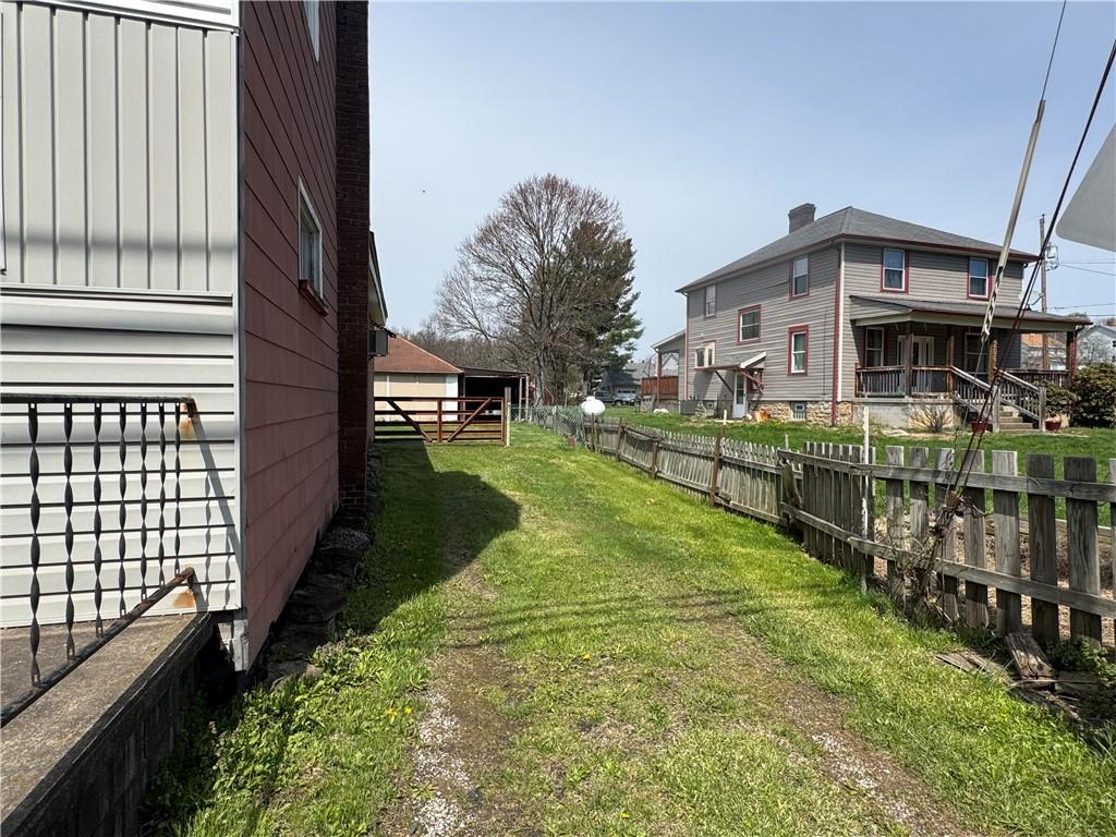 797 Walnut Hill Road Uniontown, PA 15401 - Photo 33 of 39 a view of a house with a yard and potted plants