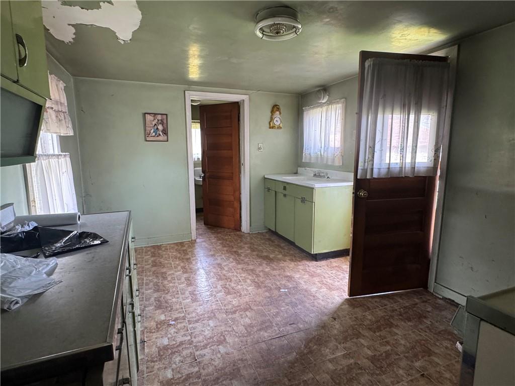 797 Walnut Hill Road Uniontown, PA 15401 - Photo 8 of 39 a view of a kitchen with fridge and wooden floor