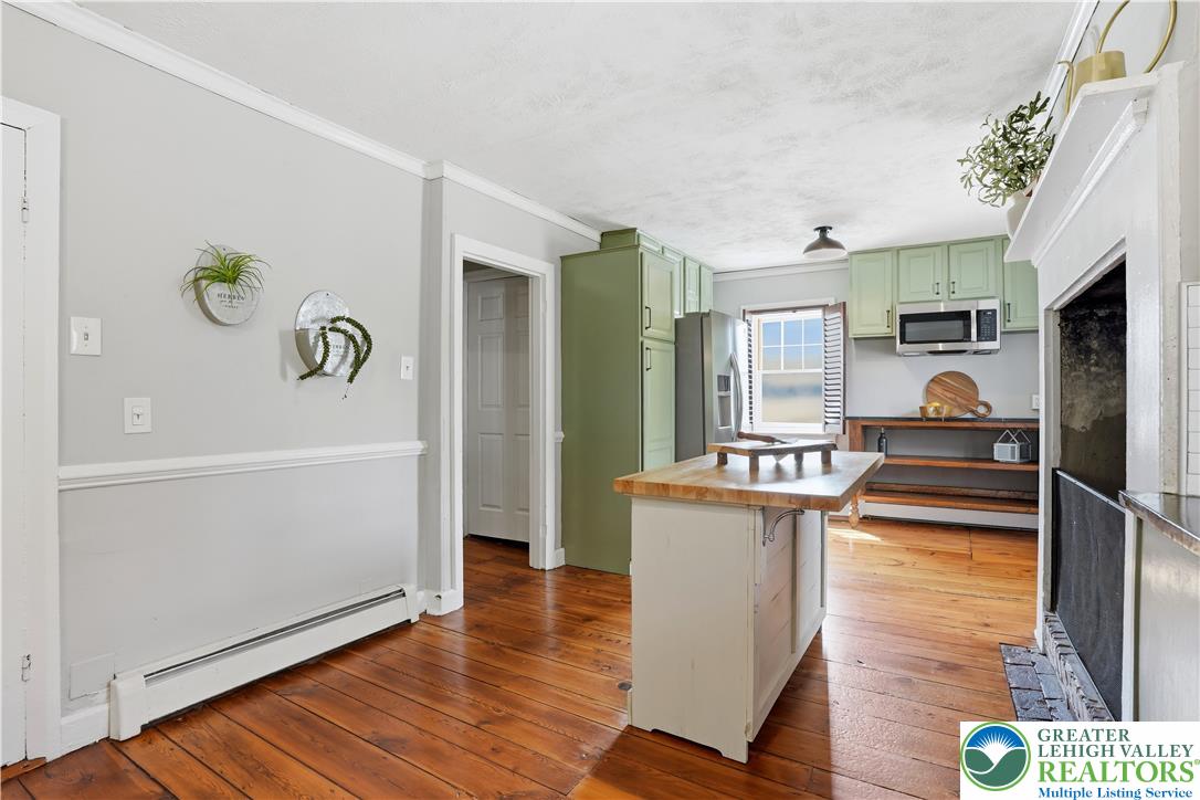 2014 Linden Street Bethlehem, PA 18017 - Photo 27 of 85 A well-appointed kitchen features natural hardwood flooring and a fireplace, ideal for culinary creations and cozy gatherings.
