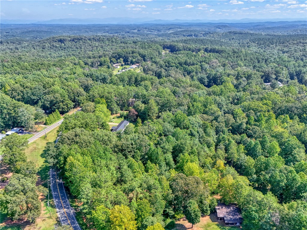 0 Burnt Tanyard Road West Union, SC 29696 - Photo 7 of 7 Lush rolling hills and mature forest frame this aerial perspective of the countryside landscape.