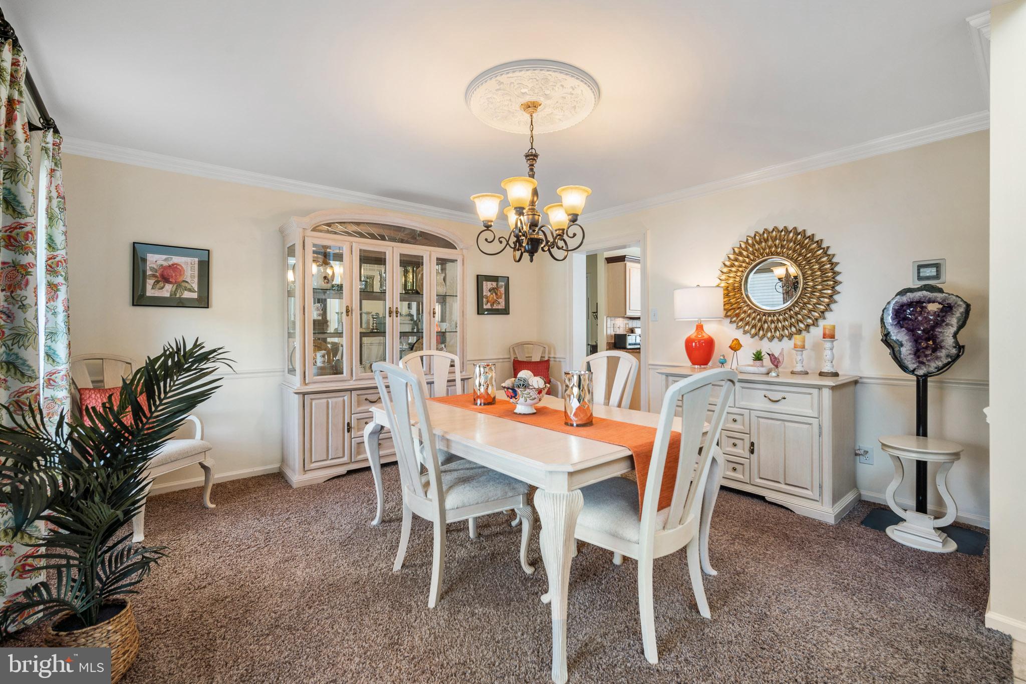 109 Brookside Way Mullica Hill, NJ 08062 - Photo 14 of 41 a dining room with furniture potted plants and a chandelier