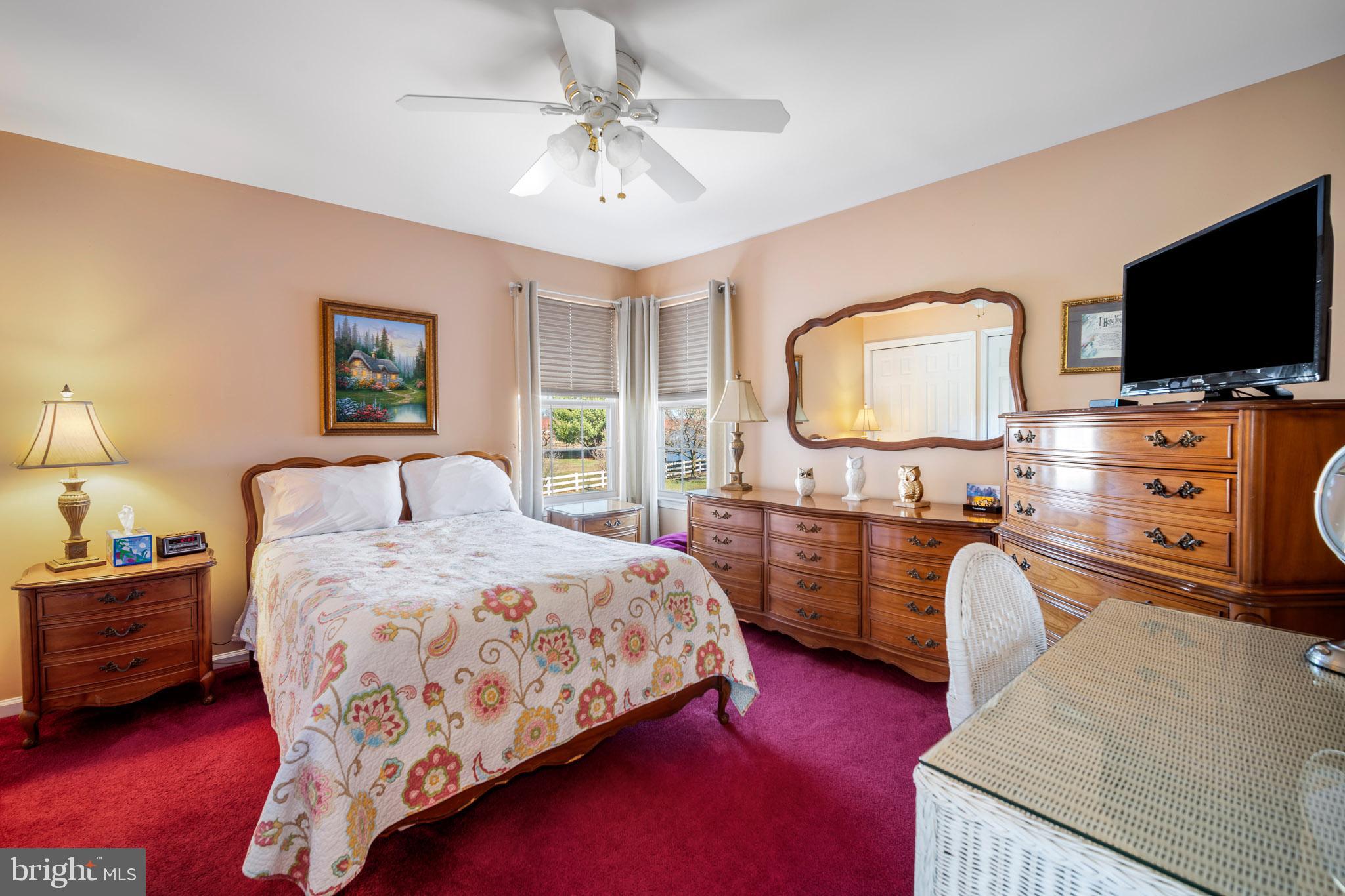 109 Brookside Way Mullica Hill, NJ 08062 - Photo 23 of 41 a bedroom with a bed and a flat screen tv