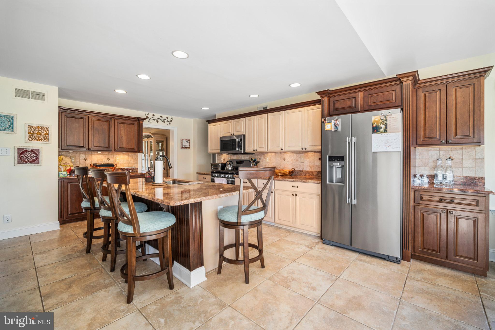 109 Brookside Way Mullica Hill, NJ 08062 - Photo 10 of 41 a kitchen with refrigerator and chairs