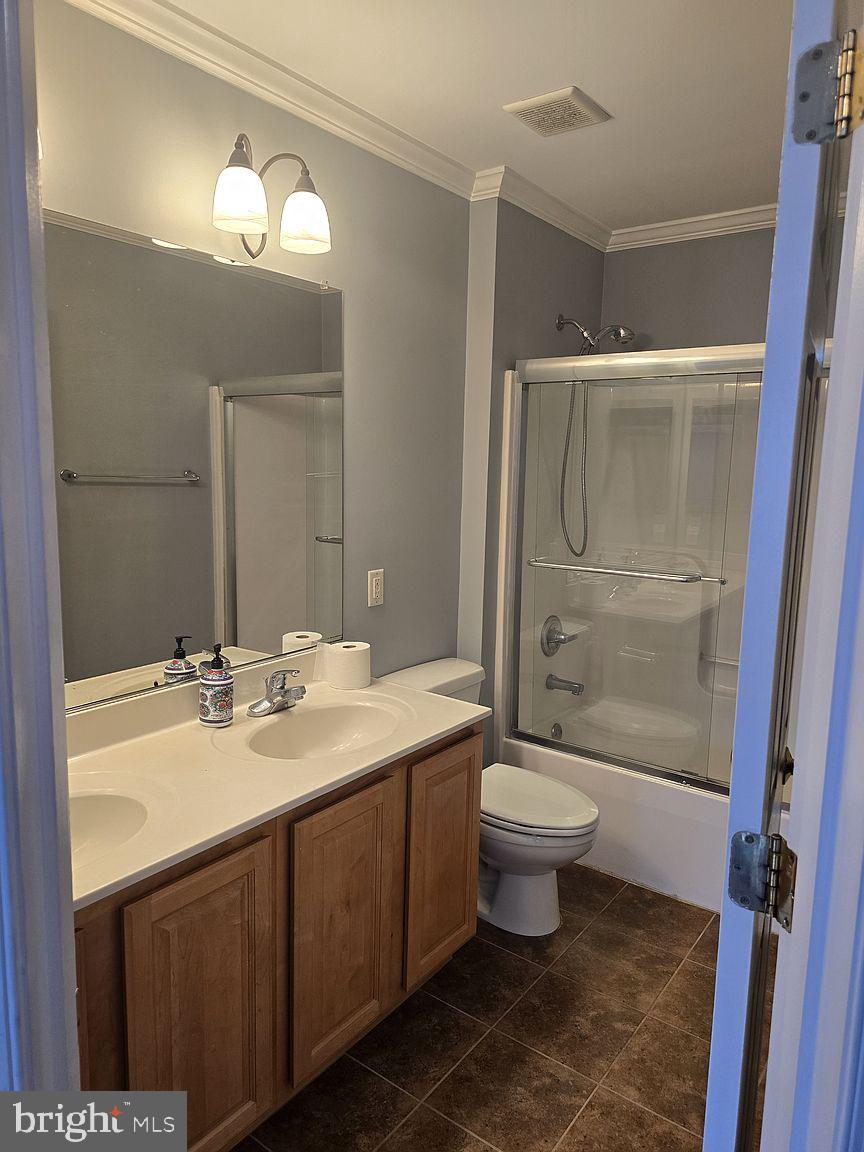 3917 Edith Court Ellicott City, MD 21043 - Photo 13 of 27 a bathroom with a double vanity sink toilet and shower