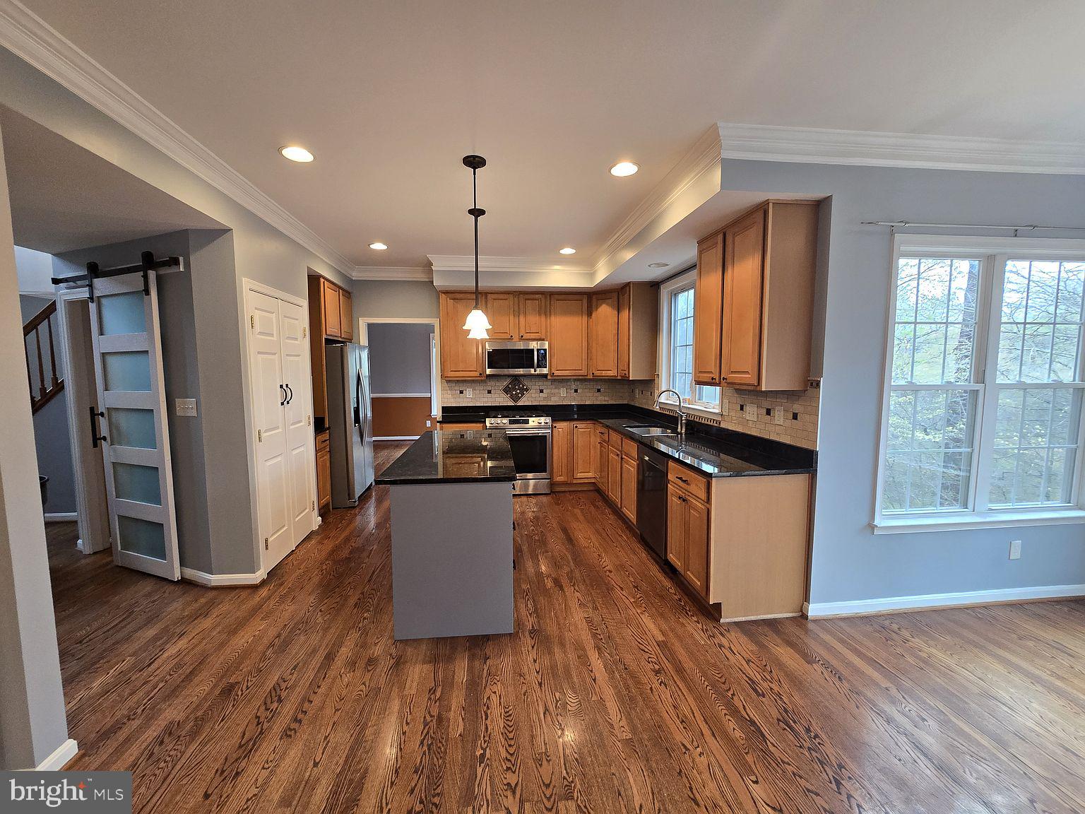 3917 Edith Court Ellicott City, MD 21043 - Photo 5 of 27 a kitchen with stainless steel appliances kitchen island granite countertop wooden floors and sink