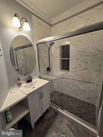 a view of an empty room with wooden floor and closet