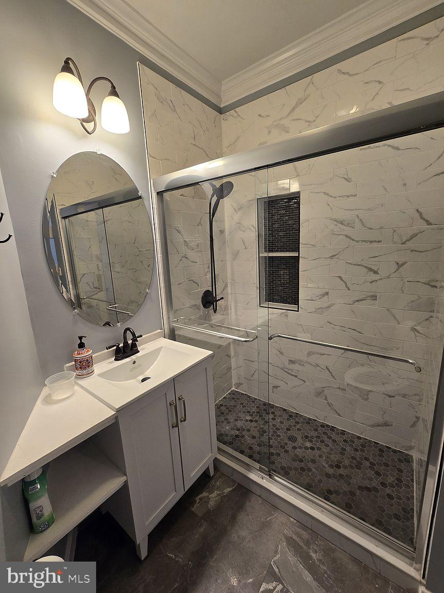 3917 Edith Court Ellicott City, MD 21043 - Photo 7 of 27 a bathroom with a sink and a mirror