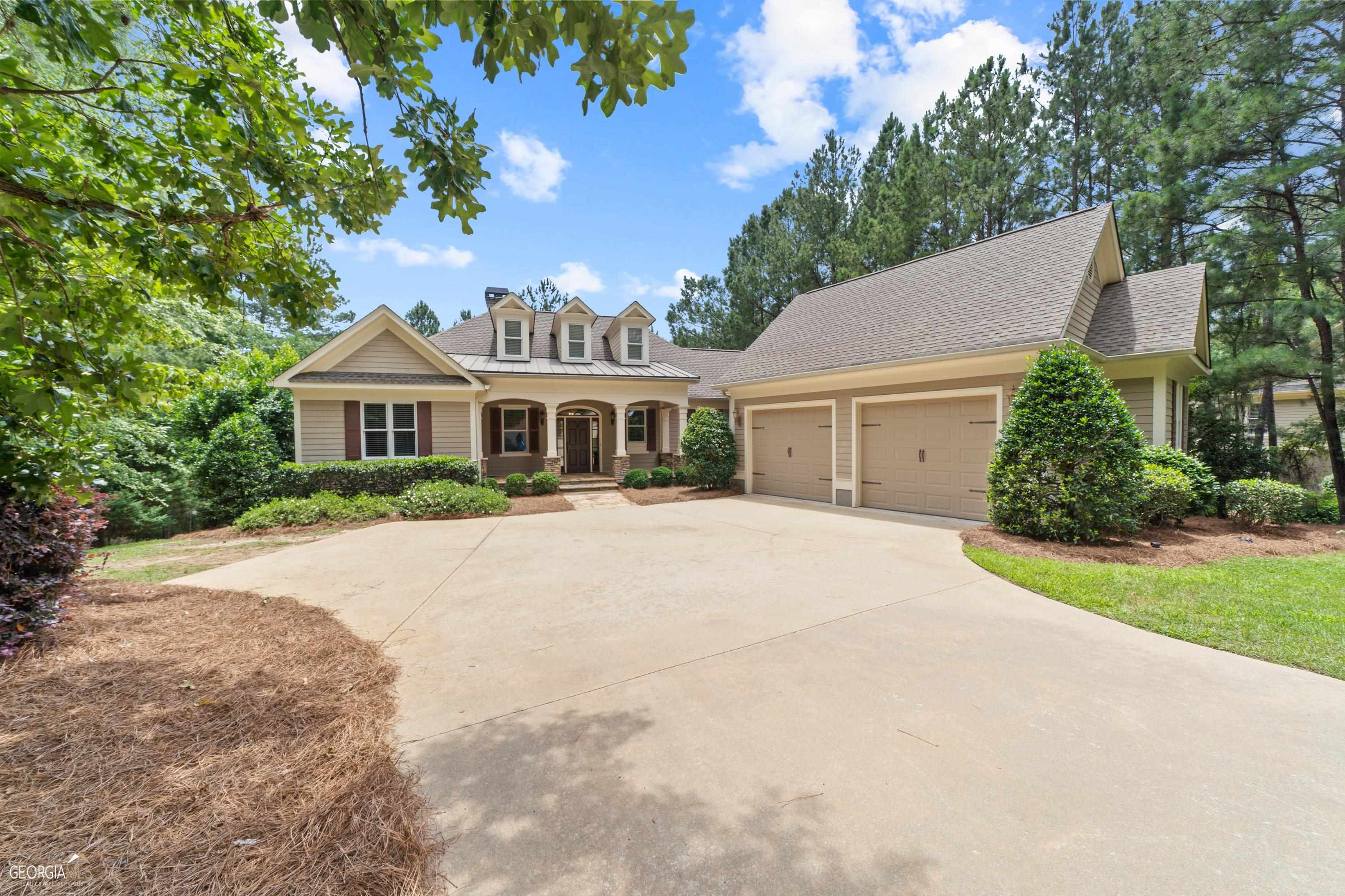 a front view of a house with a garden