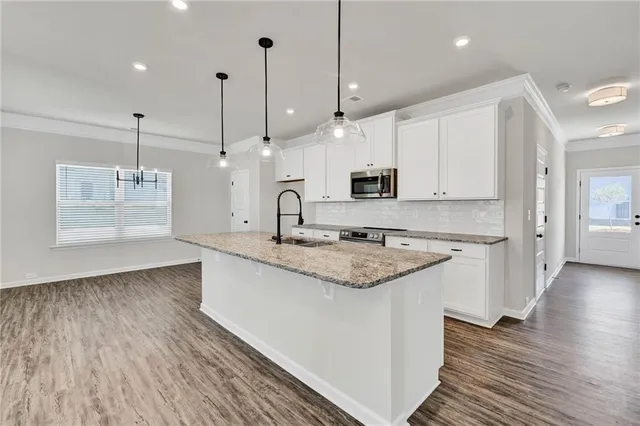 a bathroom with a granite countertop sink a large mirror and vanity
