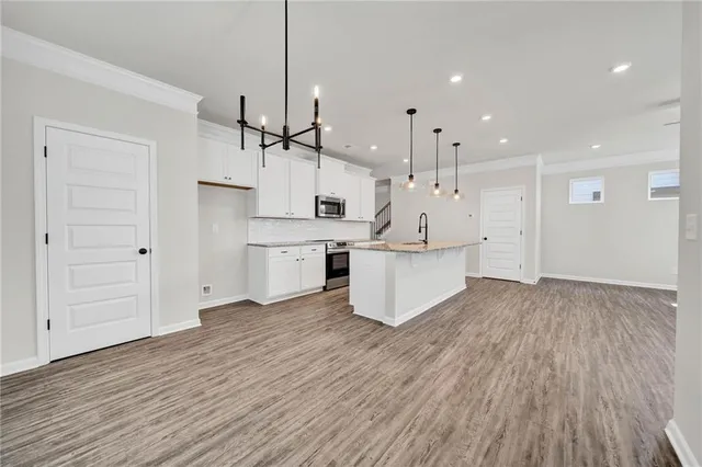 a view of a kitchen with electric appliances