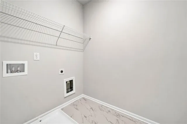 a front view of house with yard and trees in the background