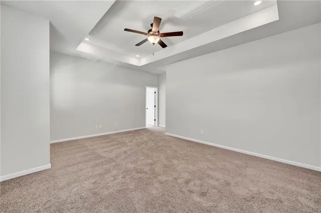 a view of a house with a yard and lawn chairs