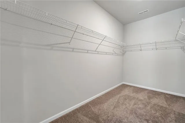 a large kitchen with a table and chairs