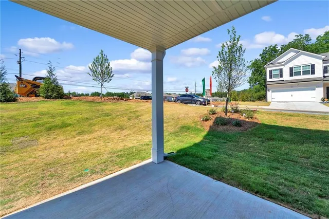 a kitchen with stainless steel appliances kitchen island granite countertop a table chairs and a refrigerator