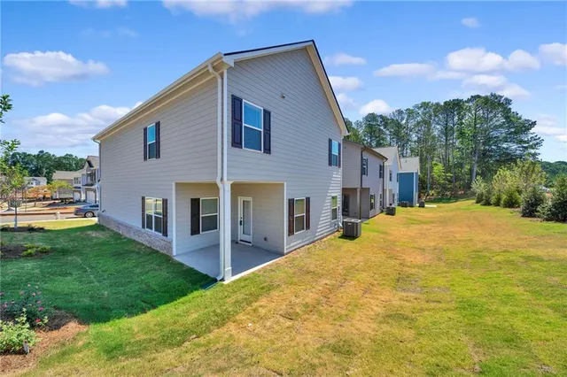 a living room with furniture kitchen view and a chandelier