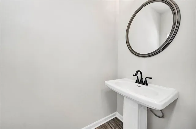 a kitchen with stainless steel appliances granite countertop a sink a stove and a wooden floors