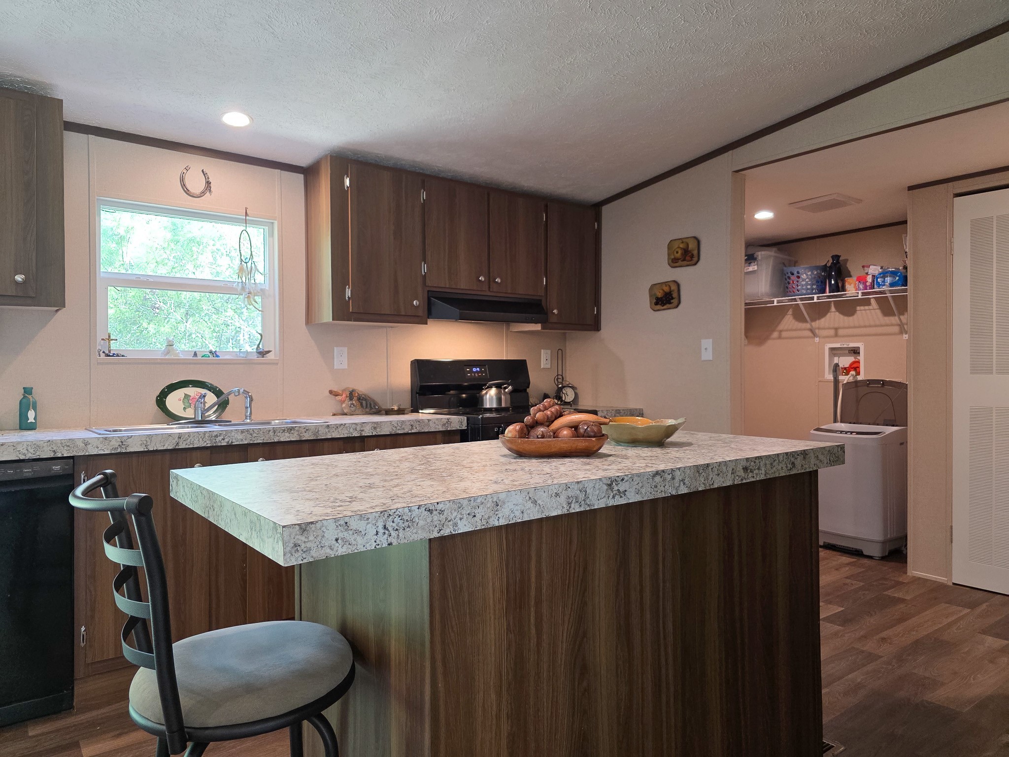 15 Great Oak Trinity, TX 75862 - Photo 3 of 13 a kitchen with a sink a table and chairs in it