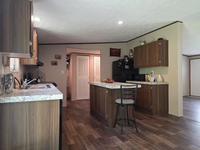 a kitchen with a refrigerator and a sink