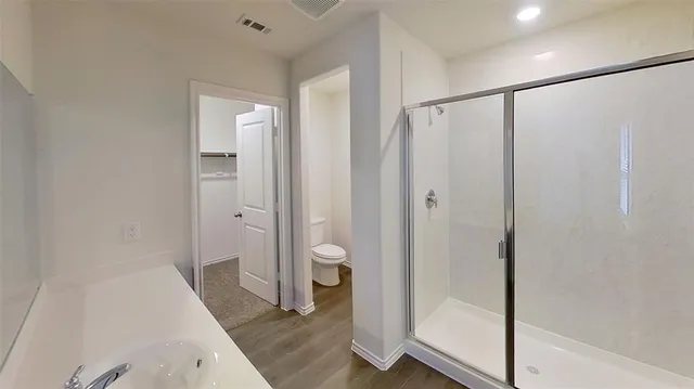 a bathroom with a shower and a sink
